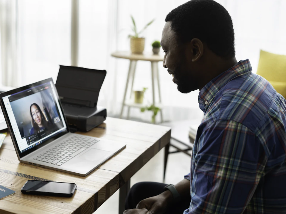A man on a video call with a colleague