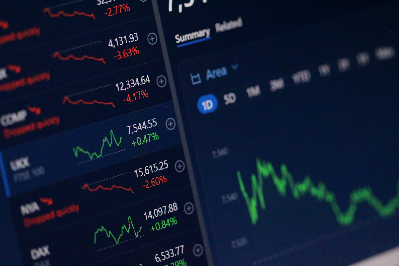 Trading charts on a screen in a dark room