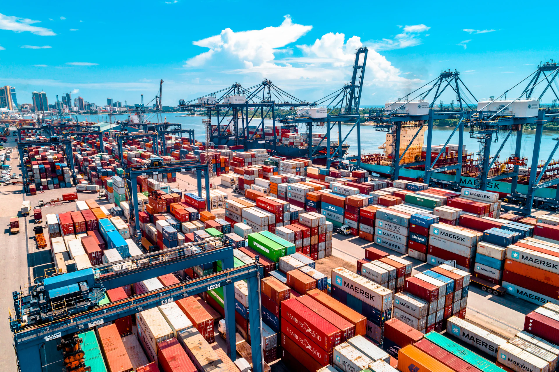 An aerial view of stacked shipping containers at a busy port